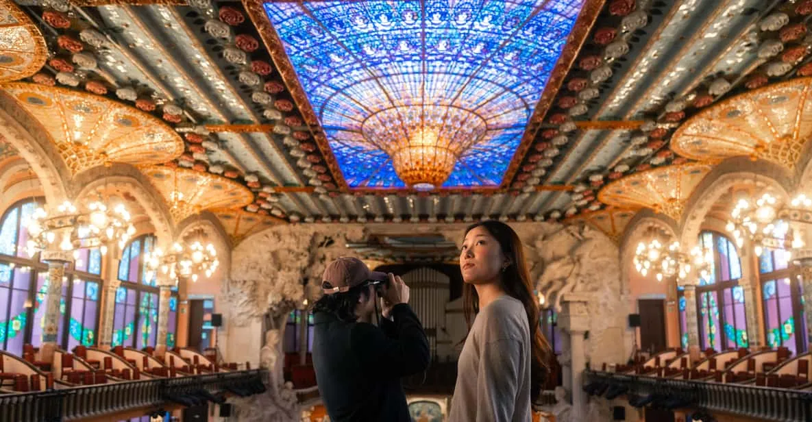 Stained-glass skylight and mosaic columns inside Palau de la Música Catalana, a museum in Barcelona, Spain